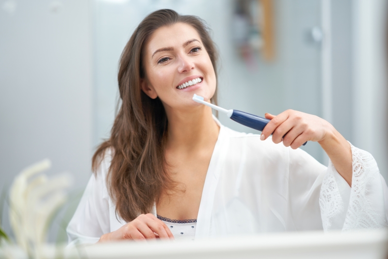  woman brush tooth in the bathroom