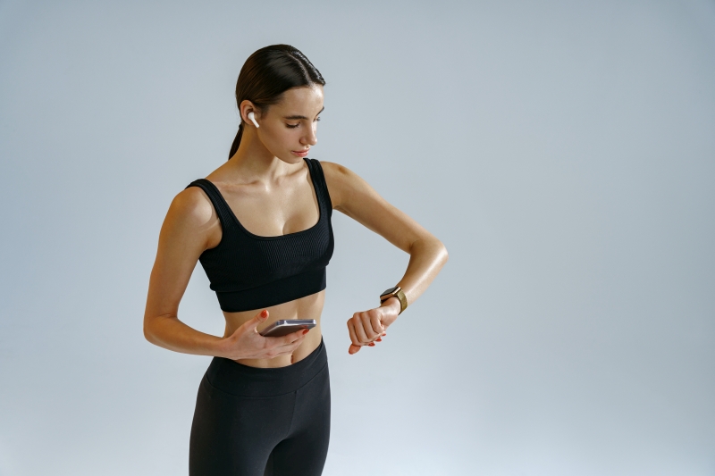 Athletic woman checking her smartwatch 